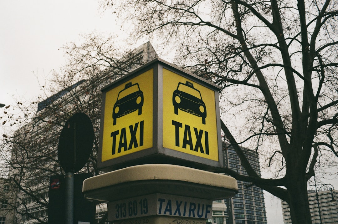 about-02 a-taxi-sign-on-top-of-a-traffic-light-3wqgrcg8syk